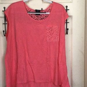 Peach colored sleeveless top with lace pocket in lace inset in back